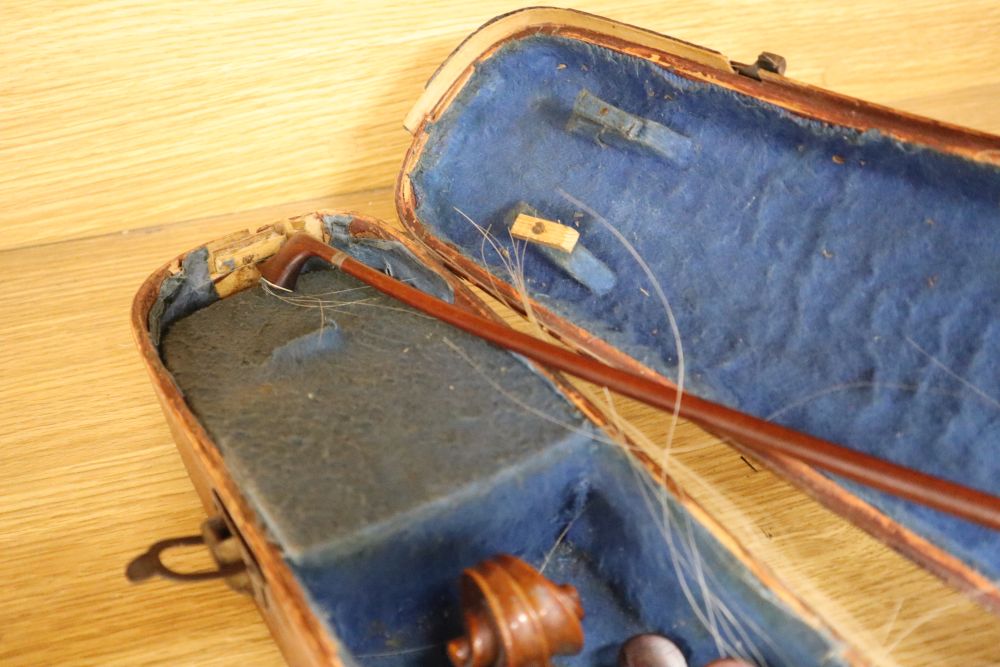 A cased violin, labelled Buthod, Paris, length of back 36cm, with bow stamped Tourte